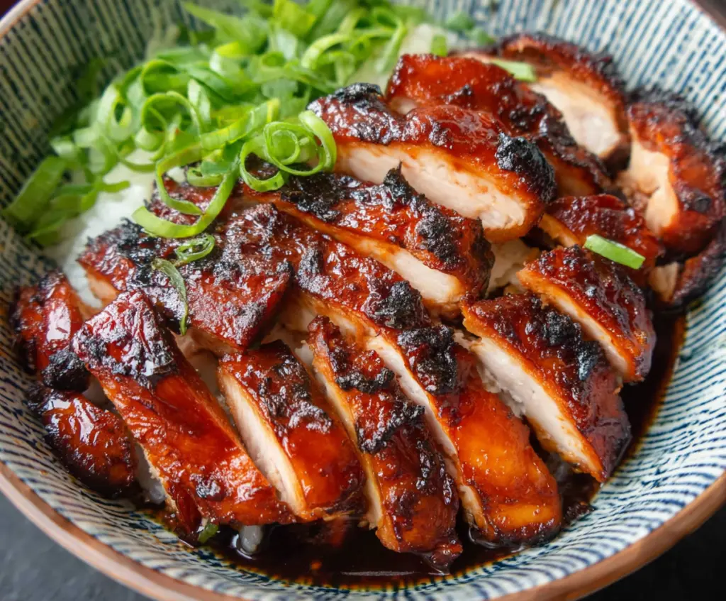 Delicious Char Siu Chicken with caramelized glaze and tender meat on a white plate.